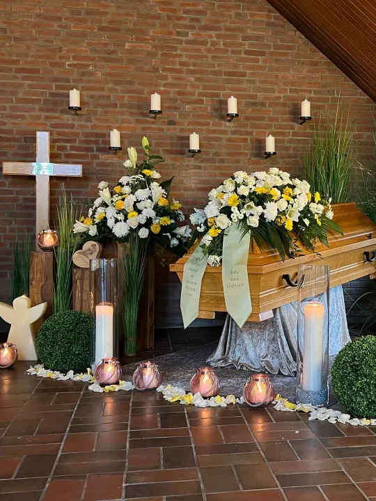 Coffin decorated with yellow and white flowers